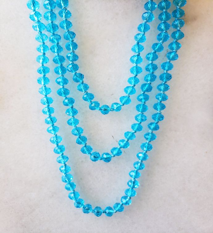 Aqua Blue Crystal Necklace Delicately Spaced With Decorative Knot